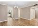 Open-concept living space with modern flooring and neutral color scheme, flowing into dining area at 1730 Manasota Beach Rd # 204, Englewood, FL 34223