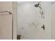Bright shower features marble-look tiling, handheld shower head, and brushed nickel hardware at 1730 Manasota Beach Rd # 204, Englewood, FL 34223