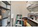 Storage area features ample shelving, step ladder, and various household items at 1730 Manasota Beach Rd # 204, Englewood, FL 34223