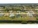 Aerial view of a suburban neighborhood, showcasing homes with swimming pools and canal access at 209 Fairway Rd, Rotonda West, FL 33947