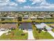 Aerial view of a residential home, set back on a generous lot within a neatly planned community at 209 Fairway Rd, Rotonda West, FL 33947