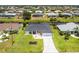 Aerial view of a charming home with a well-kept yard, set in a neighborhood with waterfront access at 209 Fairway Rd, Rotonda West, FL 33947