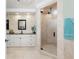 Bathroom featuring tiled walls, granite countertops, and glass shower with rainfall showerhead at 209 Fairway Rd, Rotonda West, FL 33947