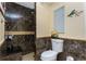 Modern bathroom with sleek marble shower, a stylish toilet, and natural light creating a spa-like experience at 209 Fairway Rd, Rotonda West, FL 33947