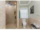Bathroom featuring tiled walls, granite countertops, glass shower, and natural light at 209 Fairway Rd, Rotonda West, FL 33947