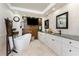 Luxurious bathroom with freestanding tub, wood-paneled accent wall, and double sink vanity at 209 Fairway Rd, Rotonda West, FL 33947