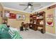 Cozy bedroom with ceiling fan, built-in shelves, and office space, perfect for relaxation and productivity at 209 Fairway Rd, Rotonda West, FL 33947
