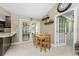 Charming dining area with French doors, a wooden table set, and view to the pool area at 209 Fairway Rd, Rotonda West, FL 33947