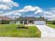 Beautiful single Gathering home with a well-manicured lawn, a long drive way, and lovely landscaping at 209 Fairway Rd, Rotonda West, FL 33947