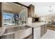 The modern kitchen features stainless steel sink, granite counters, pool view, and access to the main living area at 209 Fairway Rd, Rotonda West, FL 33947