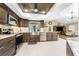 This is a well-designed kitchen with granite counters, stainless steel appliances and wooden cabinetry at 209 Fairway Rd, Rotonda West, FL 33947