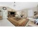Well-lit living room with a large rug, vaulted ceilings, light-colored paint, and entertainment center at 209 Fairway Rd, Rotonda West, FL 33947