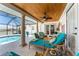 Relaxing outdoor patio featuring comfortable seating, ceiling fan, and views of the inviting screened pool at 209 Fairway Rd, Rotonda West, FL 33947