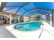 Stunning screened-in pool with inviting blue water, and an adjacent patio for lounging and outdoor enjoyment at 209 Fairway Rd, Rotonda West, FL 33947