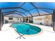 Refreshing screened-in pool surrounded by a spacious patio, perfect for enjoying sunny days and outdoor activities at 209 Fairway Rd, Rotonda West, FL 33947