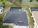 Aerial view of a property featuring a pool enclosure and a well-maintained roof at 21 Sportsman Way, Rotonda West, FL 33947