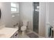 Bright bathroom with tiled floors, a step-in shower, and white cabinets at 21 Sportsman Way, Rotonda West, FL 33947