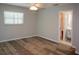 Spacious bedroom featuring wood-look floors, a ceiling fan, and an ensuite bathroom at 21 Sportsman Way, Rotonda West, FL 33947