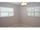 Bedroom with a ceiling fan, light-filled windows with blinds, and neutral walls at 21 Sportsman Way, Rotonda West, FL 33947