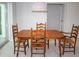 Cozy dining area featuring wooden table set, modern light fixture, and sliding glass doors at 21 Sportsman Way, Rotonda West, FL 33947