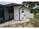 Exterior shot of house showing white rock landscaping, pool filter and black gutters at 21 Sportsman Way, Rotonda West, FL 33947