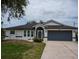 Charming single-story home with a well-manicured front yard and attached two-car garage at 21 Sportsman Way, Rotonda West, FL 33947