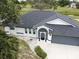 Landscaped home featuring a driveway, elegant front entrance, and meticulously maintained landscaping at 21 Sportsman Way, Rotonda West, FL 33947