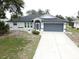 Charming home featuring a well-kept lawn, tasteful landscaping, and a two-car garage at 21 Sportsman Way, Rotonda West, FL 33947