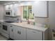 Bright kitchen featuring white appliances, neutral countertops, and natural light from a window at 21 Sportsman Way, Rotonda West, FL 33947
