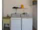 A dedicated laundry area with washer, dryer, and wash sink increases the home's functionality and convenience at 21 Sportsman Way, Rotonda West, FL 33947