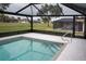 Backyard swimming pool with screened in enclosure at 21 Sportsman Way, Rotonda West, FL 33947