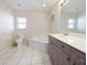 Bright bathroom featuring a soaking tub, toilet, and vanity with granite counters and wood cabinets at 2295 Chilcote Ter, Port Charlotte, FL 33981