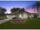 Charming home with lush lawn, mature palms, and arched window by the entryway creates a welcoming curb appeal at 2295 Chilcote Ter, Port Charlotte, FL 33981