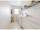 Functional laundry room with appliances, shelving, and a sink for added convenience at 2295 Chilcote Ter, Port Charlotte, FL 33981