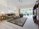 Spacious living room with view of lanai, pool, neutral carpet and vaulted ceilings for relaxing and entertaining at 2295 Chilcote Ter, Port Charlotte, FL 33981