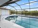 Relaxing screened-in pool area with serene water views, creating a peaceful outdoor retreat at 2295 Chilcote Ter, Port Charlotte, FL 33981