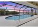 Screened pool offers a stunning waterfront view and a private area for relaxation and entertainment at 2295 Chilcote Ter, Port Charlotte, FL 33981