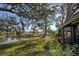 Lush backyard with beautiful plants and trees, offering serene lake views at 232 Southampton Ln # 259, Venice, FL 34293