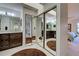 Large bathroom includes a vanity, granite countertops, and a corner closet with mirrored doors at 232 Southampton Ln # 259, Venice, FL 34293