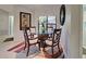 Intimate dining space featuring a glass table with rattan base, complemented by stylish chairs and natural light at 232 Southampton Ln # 259, Venice, FL 34293