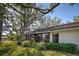 Side view of the home showcasing well-maintained landscaping and a screened-in lanai at 232 Southampton Ln # 259, Venice, FL 34293