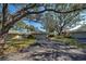 Single-story home with a two-car garage, driveway, lush lawn, and mature trees at 232 Southampton Ln # 259, Venice, FL 34293