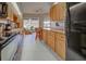 Well-equipped kitchen with wooden cabinets, modern appliances, and a cozy breakfast bar at 232 Southampton Ln # 259, Venice, FL 34293