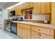 Kitchen featuring wooden cabinets, modern appliances, and a double sink at 232 Southampton Ln # 259, Venice, FL 34293