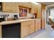 Kitchen featuring wooden cabinets, a double sink, and modern appliances at 232 Southampton Ln # 259, Venice, FL 34293