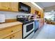 Functional kitchen with wooden cabinets, a modern oven and ample counter space at 232 Southampton Ln # 259, Venice, FL 34293