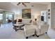 Comfortable living room featuring a white sofa set, a glass coffee table, and a ceiling fan at 232 Southampton Ln # 259, Venice, FL 34293
