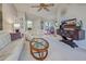 Inviting living room with white leather furniture, a glass coffee table, and a view of the dining area at 232 Southampton Ln # 259, Venice, FL 34293