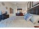 Spacious main bedroom showcasing a king bed, ample lighting, and stylish decor at 232 Southampton Ln # 259, Venice, FL 34293