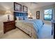Relaxing main bedroom with a king-size bed, side tables, and a view of the outdoors at 232 Southampton Ln # 259, Venice, FL 34293